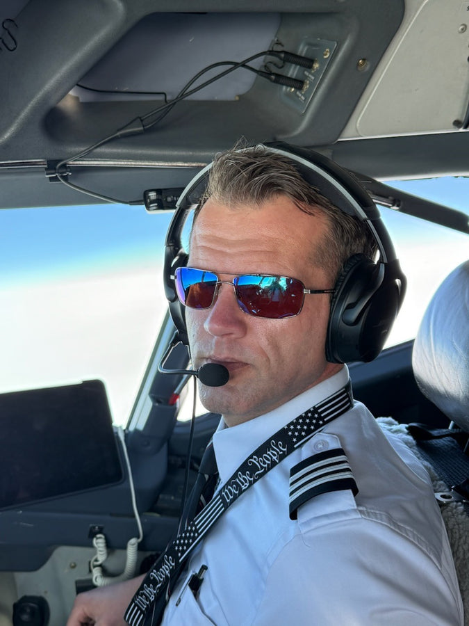 Professional pilot wearing Sky Optics sunglasses in an aircraft cockpit
